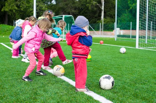 young-kids-playing-soccer-and-practing-shooting-goals